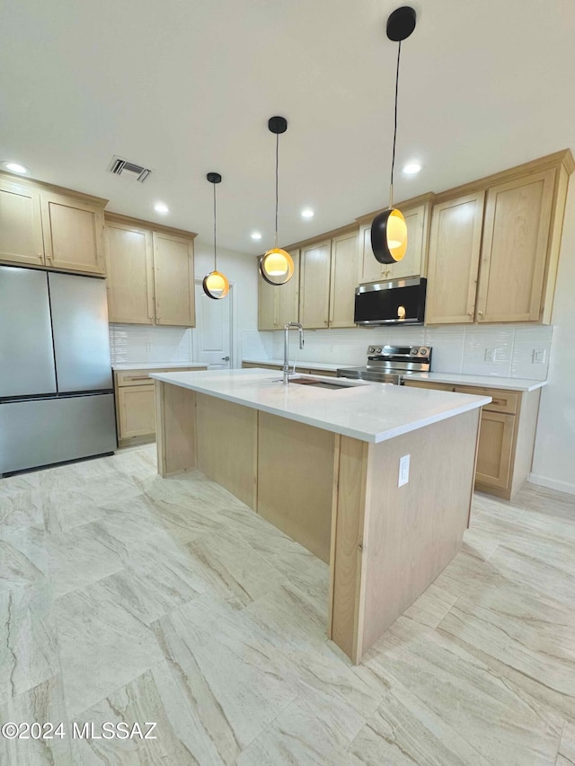 kitchen with appliances with stainless steel finishes, light brown cabinetry, sink, pendant lighting, and a center island with sink