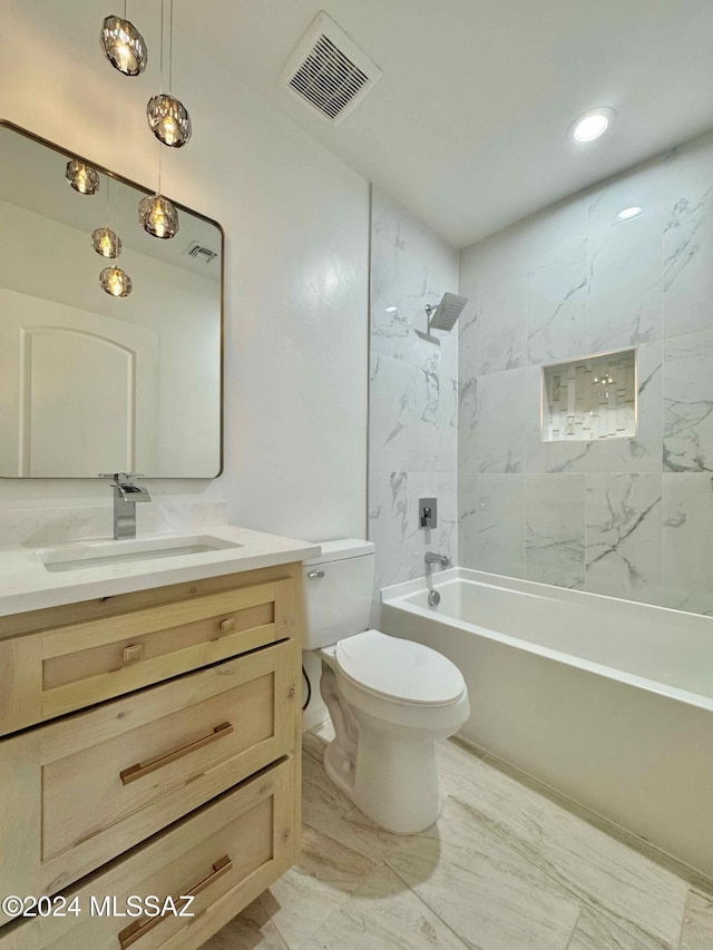 full bathroom with tiled shower / bath combo, toilet, and vanity