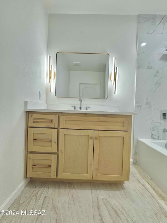 bathroom with vanity and tiled shower / bath