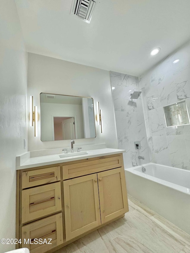 bathroom with vanity and tiled shower / bath