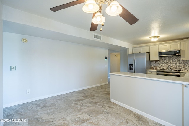 kitchen featuring tasteful backsplash, white cabinetry, ceiling fan, and appliances with stainless steel finishes