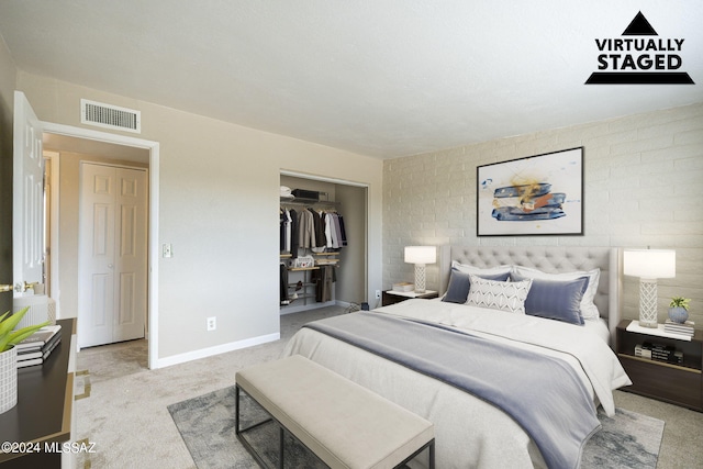 bedroom featuring a closet and light colored carpet