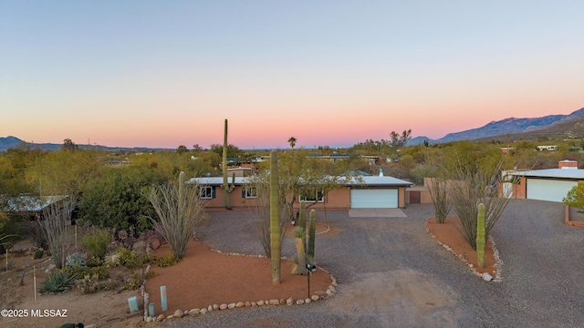 view of front of property with a mountain view and a garage