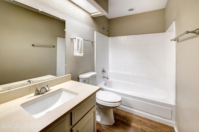 full bathroom featuring vanity, wood-type flooring, shower / bathtub combination, and toilet