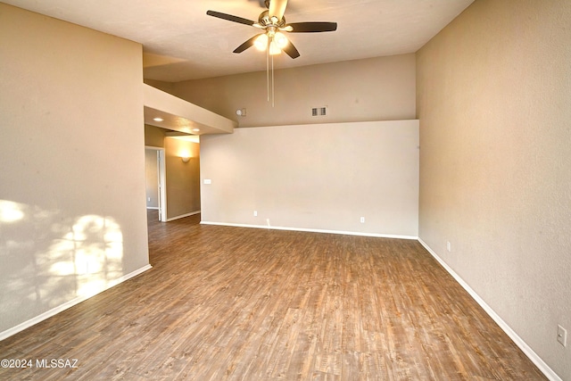 empty room featuring ceiling fan, high vaulted ceiling, and wood-type flooring