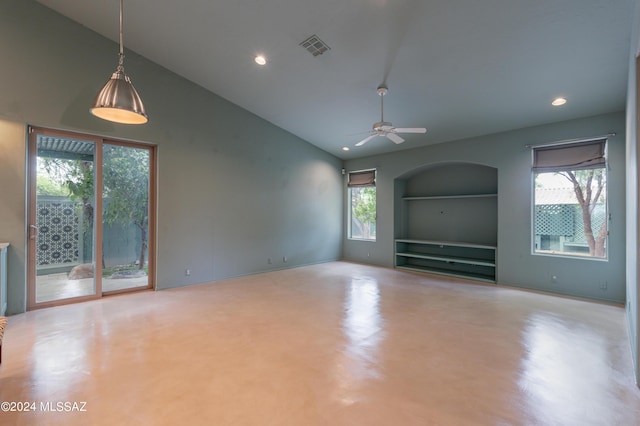 unfurnished living room featuring ceiling fan, built in features, and a healthy amount of sunlight