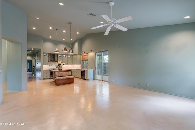 living room featuring ceiling fan and a towering ceiling