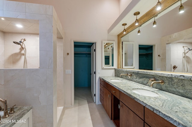 bathroom featuring tile patterned floors, vanity, and walk in shower