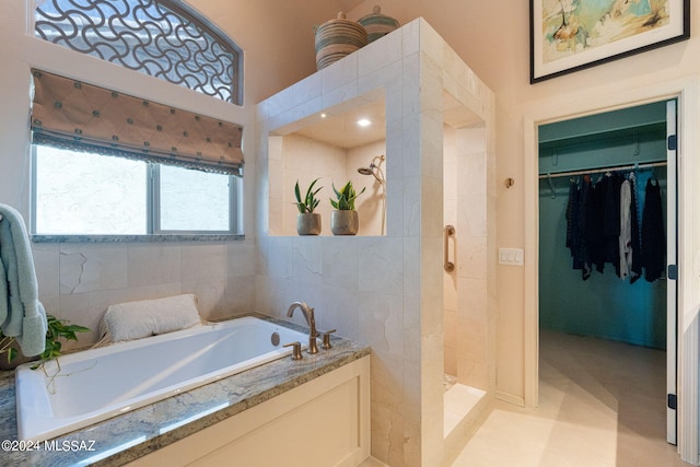 bathroom featuring separate shower and tub