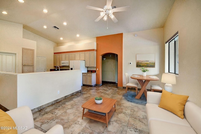 living room featuring ceiling fan and high vaulted ceiling