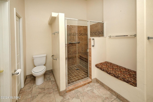 bathroom with toilet and an enclosed shower