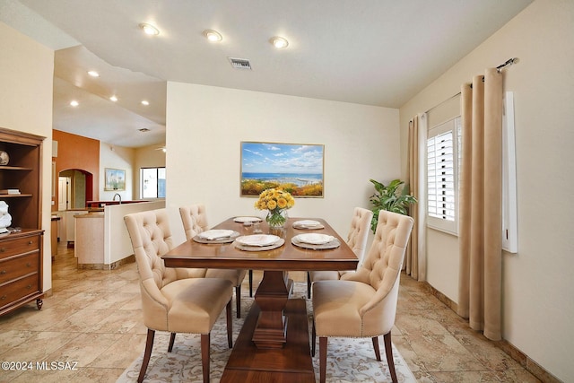 dining area with vaulted ceiling