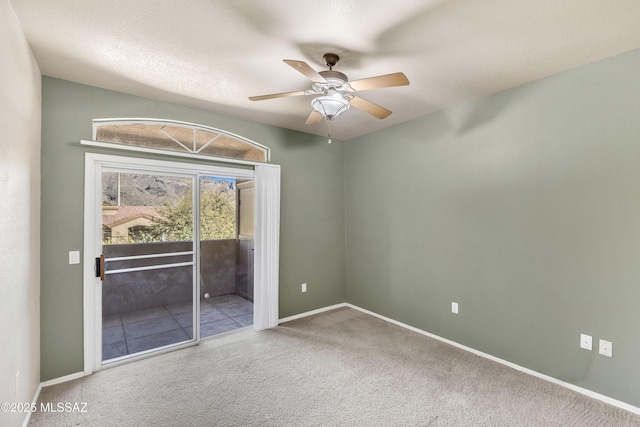 empty room featuring carpet and ceiling fan