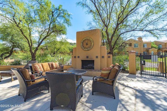 view of patio with an outdoor living space with a fireplace