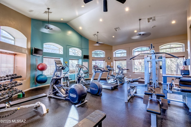 workout area featuring ceiling fan and a towering ceiling