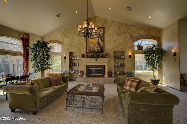 living room with an inviting chandelier, high vaulted ceiling, light colored carpet, and a tiled fireplace