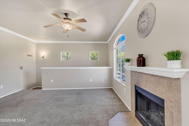 carpeted living room featuring a tiled fireplace, ceiling fan, and ornamental molding