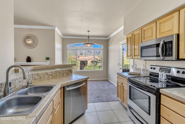 kitchen featuring light carpet, appliances with stainless steel finishes, light brown cabinetry, sink, and tile countertops