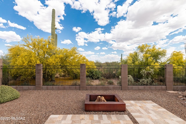 view of patio / terrace with an outdoor fire pit