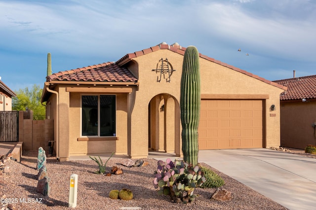 mediterranean / spanish-style house with a garage