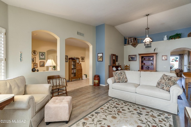 living room featuring vaulted ceiling and light hardwood / wood-style floors