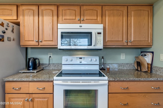 kitchen with white appliances and stone counters