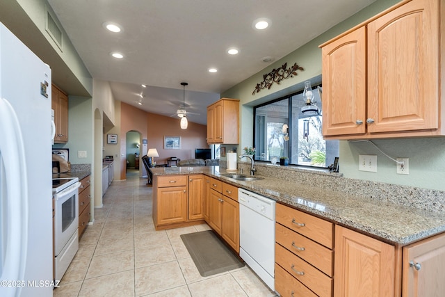 kitchen featuring sink, kitchen peninsula, pendant lighting, white appliances, and light stone countertops