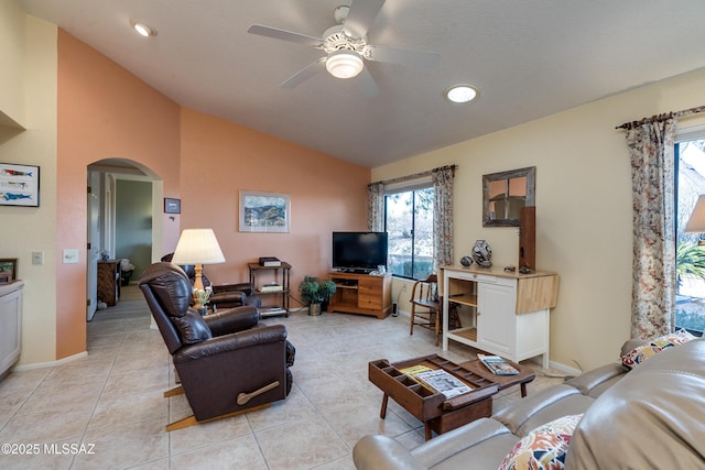 tiled living room with lofted ceiling and ceiling fan