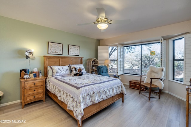 bedroom with ceiling fan and light wood-type flooring