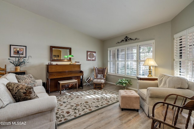 living room with hardwood / wood-style floors and vaulted ceiling