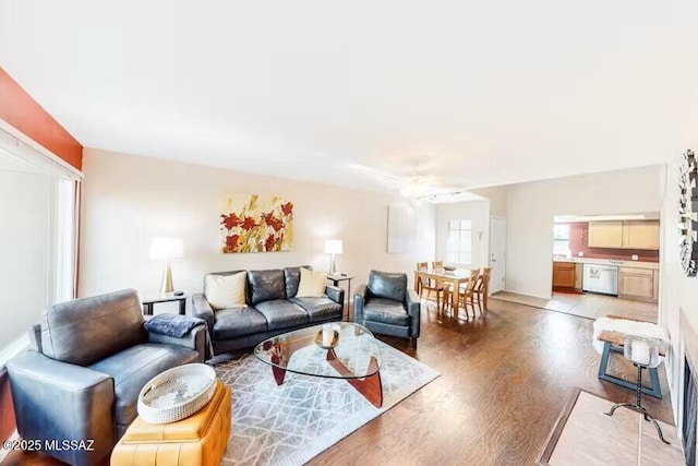 living room featuring ceiling fan, a healthy amount of sunlight, and light hardwood / wood-style flooring