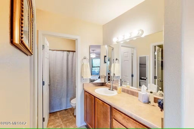 bathroom with a shower with curtain, tile patterned floors, vanity, and toilet