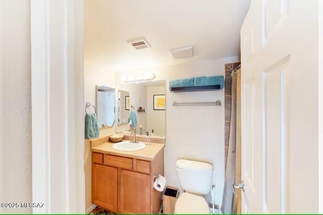 bathroom featuring toilet, a shower with shower curtain, and vanity