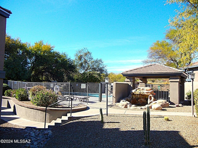 exterior space featuring a fenced in pool and a gazebo