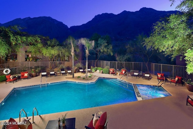 view of pool featuring a mountain view and a patio