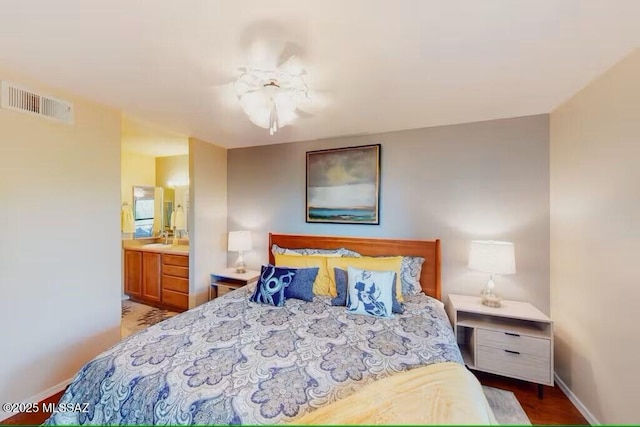 bedroom featuring ceiling fan, sink, and connected bathroom