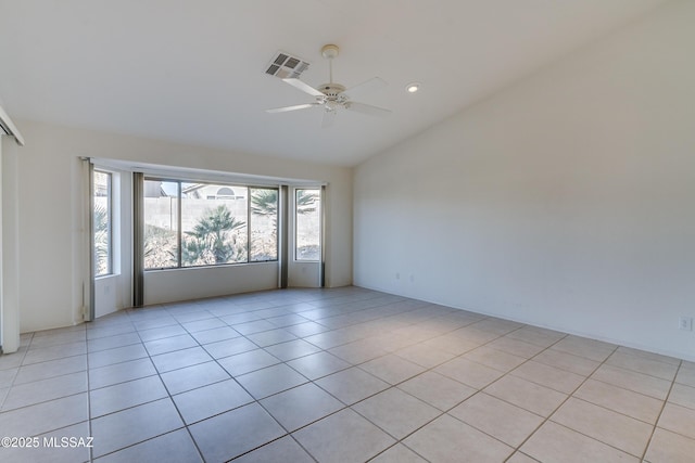 empty room with ceiling fan and light tile patterned floors