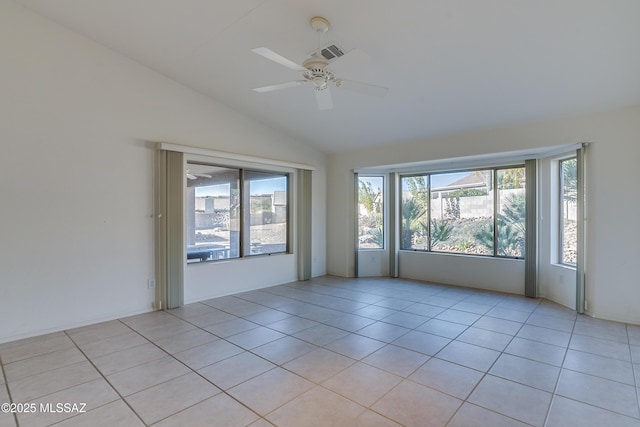 spare room featuring light tile patterned floors, ceiling fan, and lofted ceiling