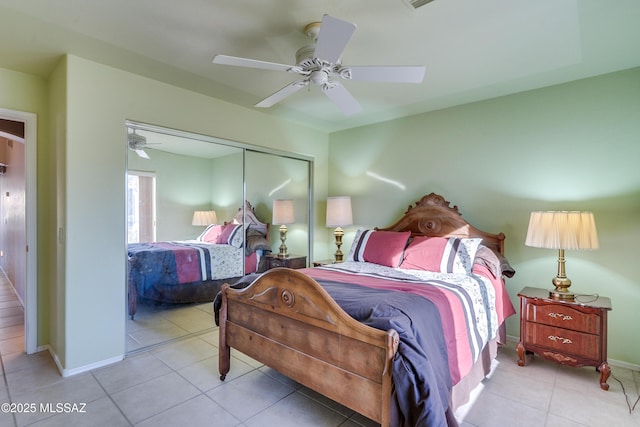 bedroom with light tile patterned floors, a closet, and ceiling fan