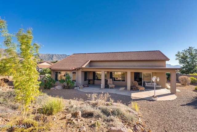 rear view of property featuring a mountain view and a patio