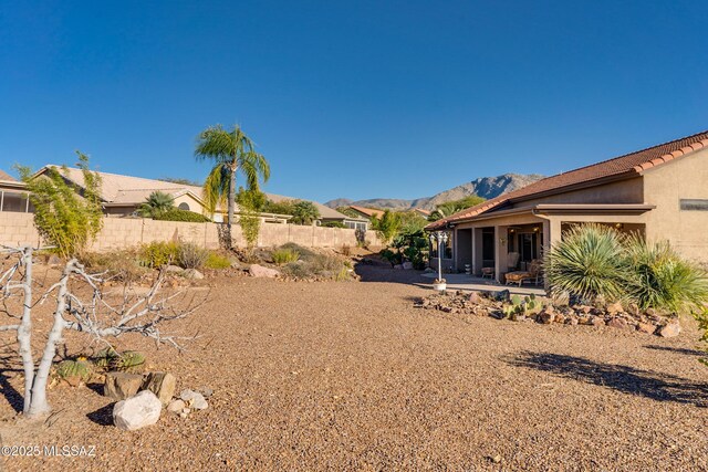 view of yard featuring a mountain view and a patio