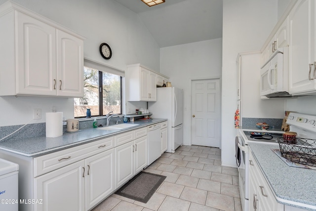 kitchen with white cabinetry, sink, vaulted ceiling, white appliances, and light tile patterned floors