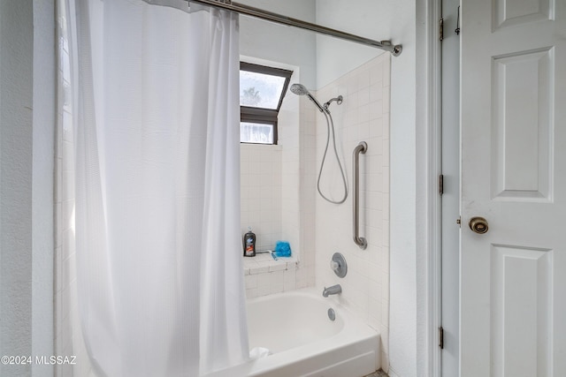 bathroom with shower / bath combo with shower curtain