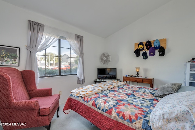 bedroom with carpet flooring and vaulted ceiling