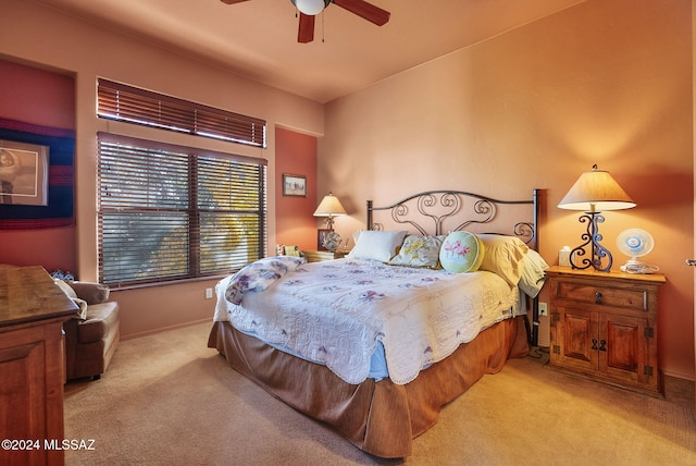 bedroom featuring ceiling fan and light carpet