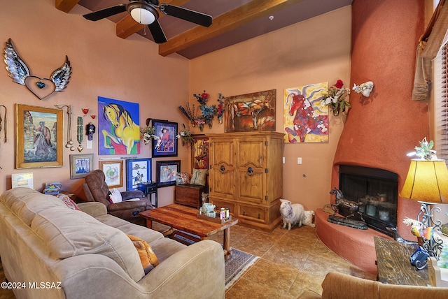 living room featuring ceiling fan, beam ceiling, light tile patterned floors, and a towering ceiling