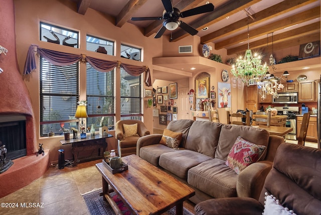 tiled living room featuring beamed ceiling, ceiling fan with notable chandelier, a towering ceiling, and a fireplace