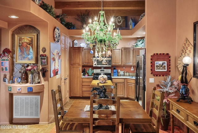 dining room with beam ceiling and an inviting chandelier