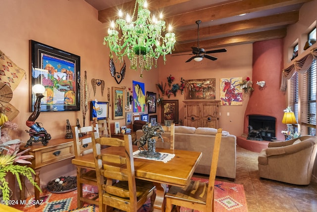 dining room with tile patterned flooring, ceiling fan with notable chandelier, and beam ceiling