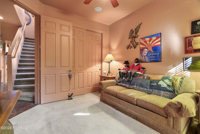 living room with ceiling fan and carpet